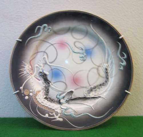 A decorative E&O China Wave display wall plate with raised dragons!