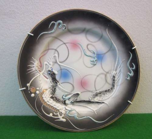 A decorative E&O China Wave display wall plate with raised dragons!