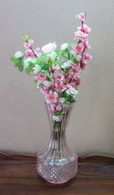 A stunning, eye catching pink glass vase!! Beautiful on display!! Lifespace Sale