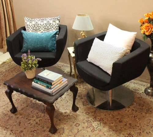 A stylish & modern pair of sleek, retro-styled black arm chairs, with thick durable fabric.