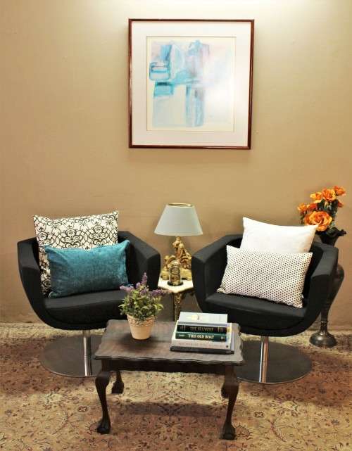 A stylish & modern pair of sleek, retro-styled black arm chairs, with thick durable fabric.