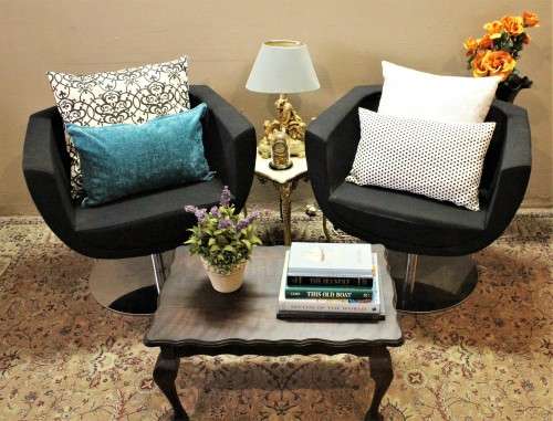 A stylish & modern pair of sleek, retro-styled black arm chairs, with thick durable fabric.