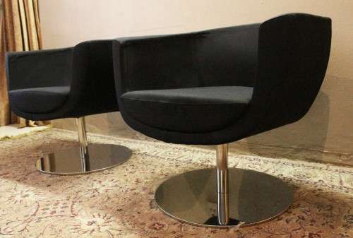 A stylish & modern pair of sleek, retro-styled black arm chairs, with thick durable fabric.