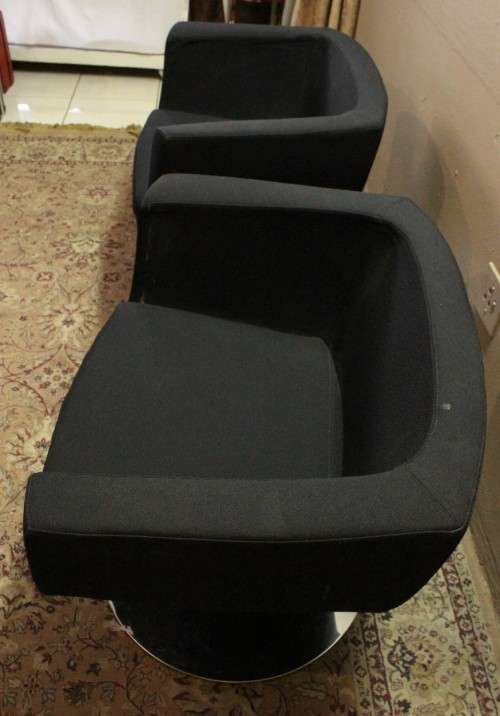 A stylish & modern pair of sleek, retro-styled black arm chairs, with thick durable fabric.