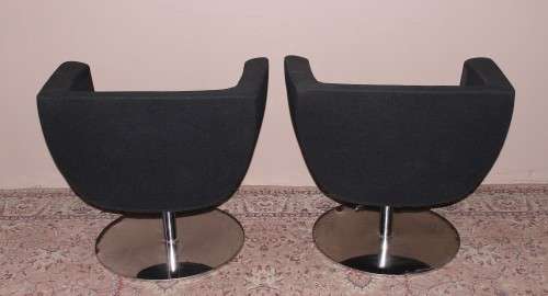 A stylish & modern pair of sleek, retro-styled black arm chairs, with thick durable fabric.