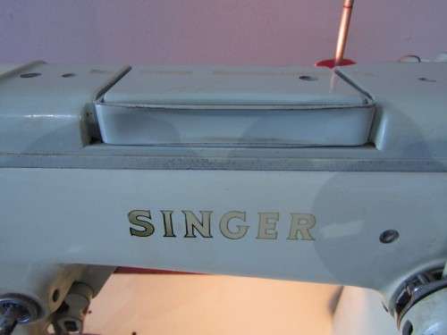 A remarkable vintage (1956-1961) Singer oak & cast iron stand with a 319K model sewing machine in