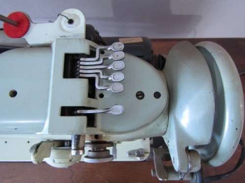 A remarkable vintage (1956-1961) Singer oak & cast iron stand with a 319K model sewing machine in