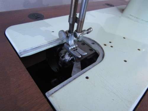 A remarkable vintage (1956-1961) Singer oak & cast iron stand with a 319K model sewing machine in