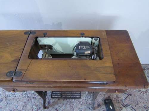 A remarkable vintage (1956-1961) Singer oak & cast iron stand with a 319K model sewing machine in