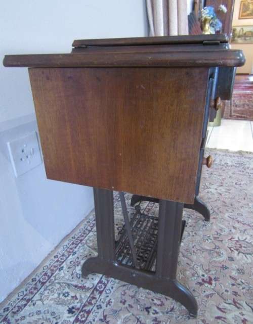 A remarkable vintage (1956-1961) Singer oak & cast iron stand with a 319K model sewing machine in