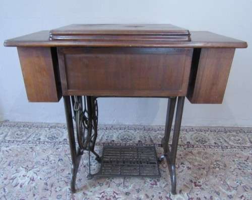 A remarkable vintage (1956-1961) Singer oak & cast iron stand with a 319K model sewing machine in
