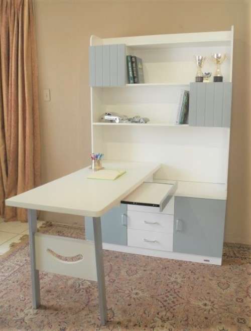 A stylish, modern `Mokki` book case with desk in white and blue.