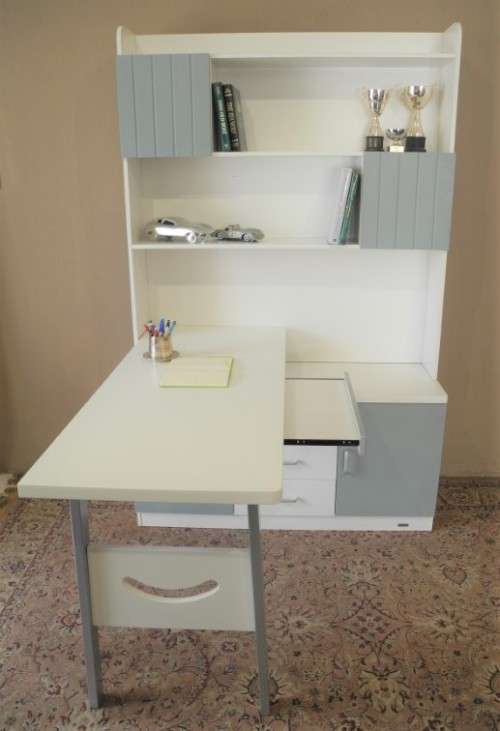 A stylish, modern `Mokki` book case with desk in white and blue.