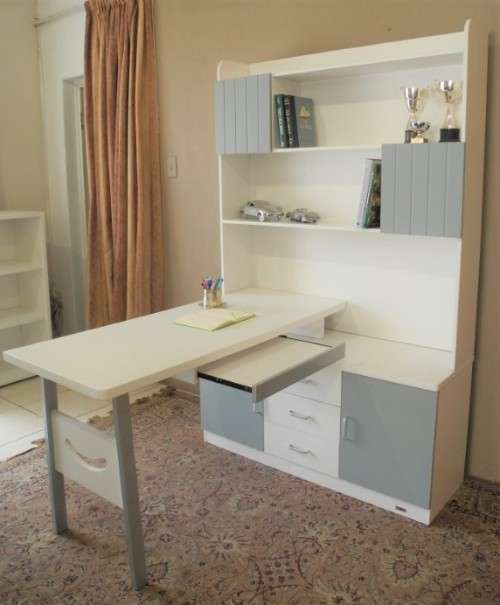 A stylish, modern `Mokki` book case with desk in white and blue.