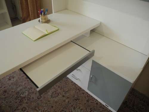 A stylish, modern `Mokki` book case with desk in white and blue.