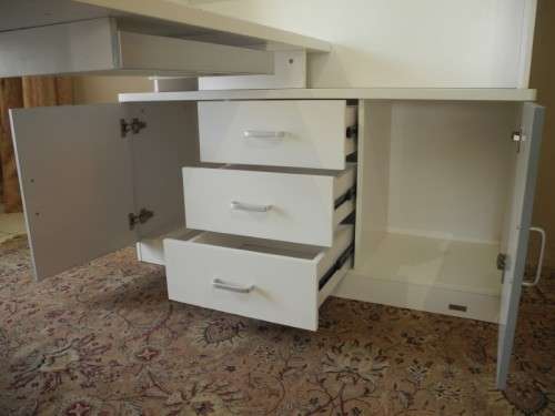 A stylish, modern `Mokki` book case with desk in white and blue.