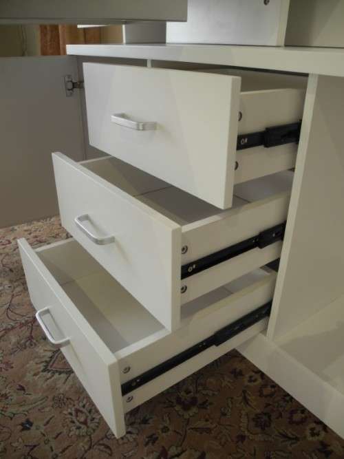 A stylish, modern `Mokki` book case with desk in white and blue.