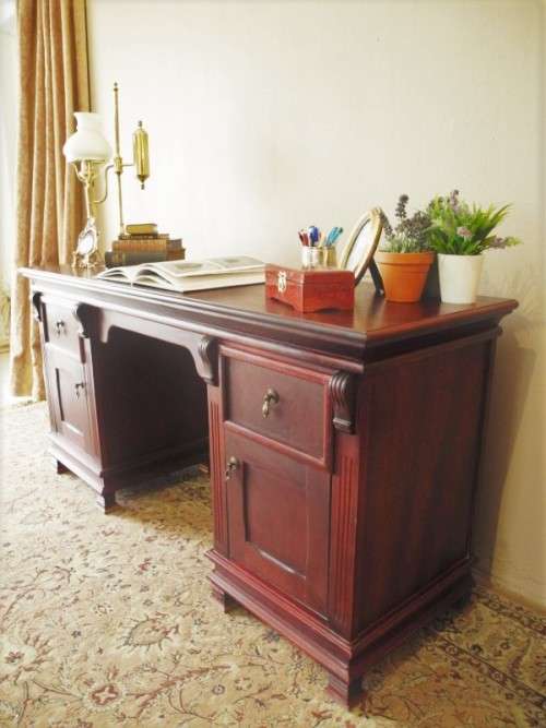 A gorgeous vintage Mahogany two-drawer, two cupboard library/ ladies writing desk w/ ornate handles