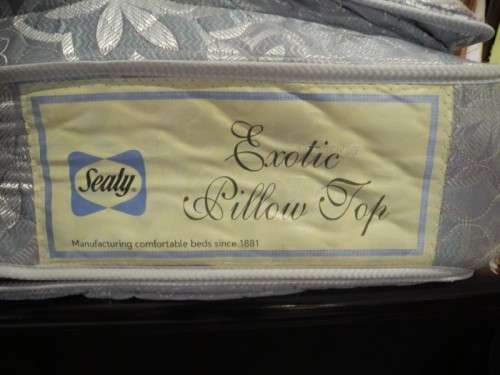 A stylish modern Coricraft Mahogany Queen sleigh bed with an Exotic pillow top mattress