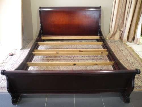 A stylish modern Coricraft Mahogany Queen sleigh bed with an Exotic pillow top mattress
