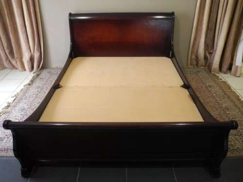 A stylish modern Coricraft Mahogany Queen sleigh bed with an Exotic pillow top mattress