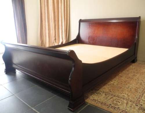 A stylish modern Coricraft Mahogany Queen sleigh bed with an Exotic pillow top mattress