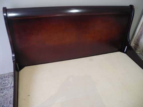 A stylish modern Coricraft Mahogany Queen sleigh bed with an Exotic pillow top mattress
