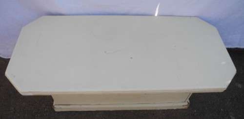 A coffee table for informal living spaces, needs some work or cover.