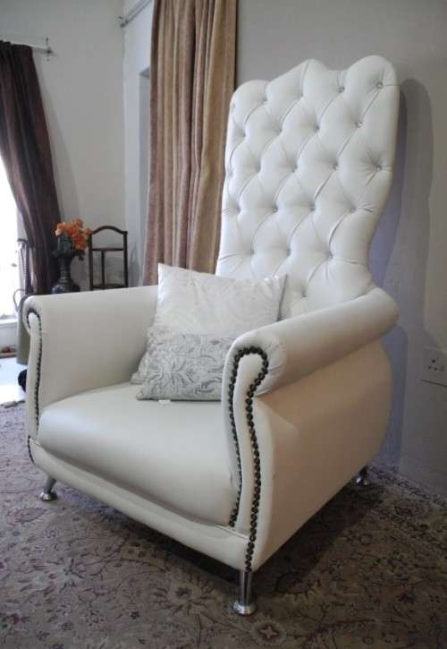 An exceptional oversized King wing back chair in a durable white faux leather. Lifespace Sale