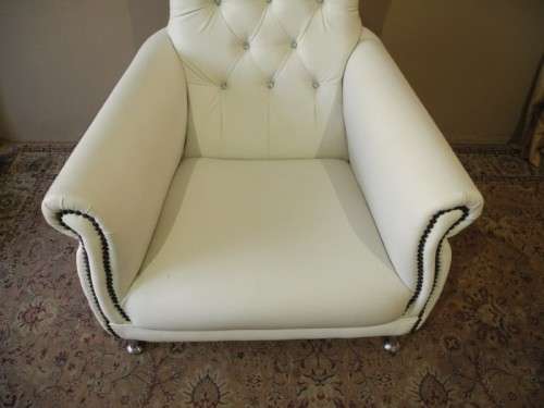 An exceptional oversized King wing back chair in a durable white faux leather. Lifespace Sale
