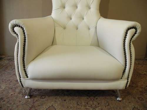 An exceptional oversized King wing back chair in a durable white faux leather. Lifespace Sale