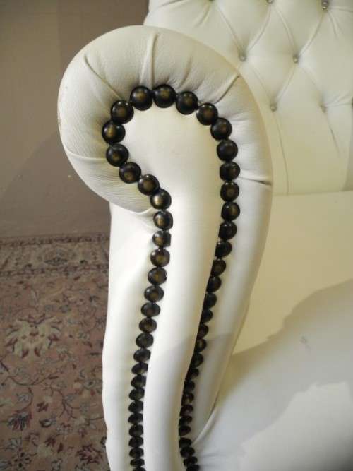 An exceptional oversized King wing back chair in a durable white faux leather. Lifespace Sale