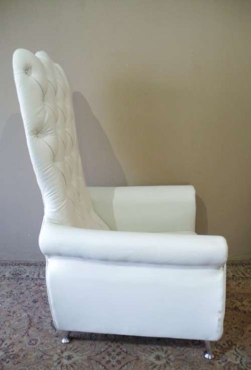 An exceptional oversized King wing back chair in a durable white faux leather. Lifespace Sale