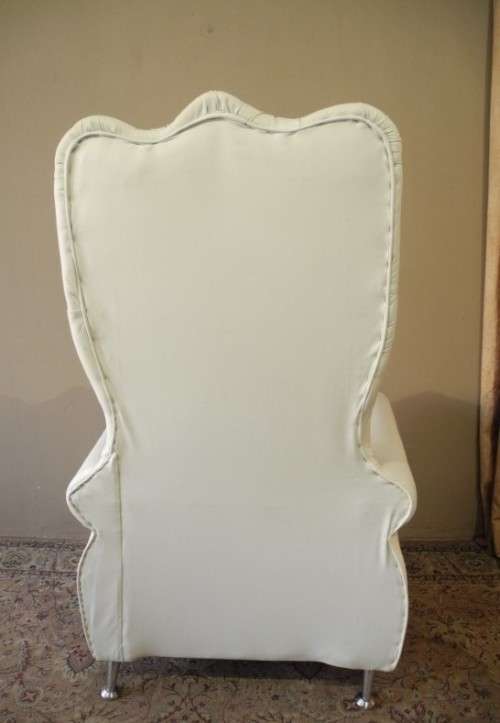 An exceptional oversized King wing back chair in a durable white faux leather. Lifespace Sale