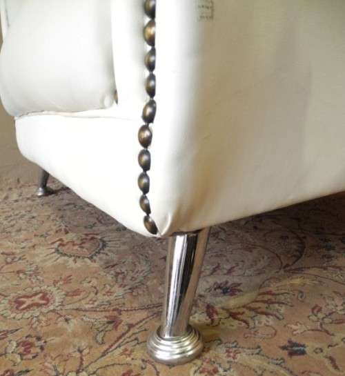 An exceptional oversized King wing back chair in a durable white faux leather. Lifespace Sale