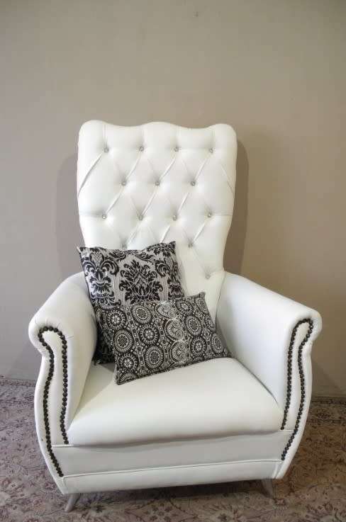 An exceptional oversized Queen wing back chair in durable white faux leather. Great "Feature" chair