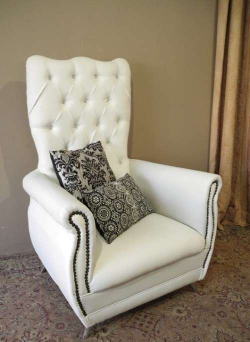 An exceptional oversized Queen wing back chair in durable white faux leather. Great "Feature" chair