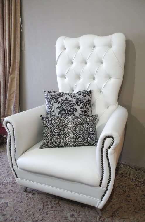 An exceptional oversized Queen wing back chair in durable white faux leather. Great "Feature" chair