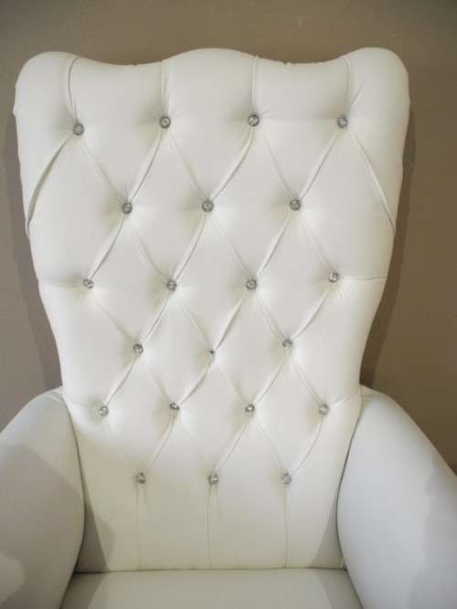 An exceptional oversized Queen wing back chair in durable white faux leather. Great "Feature" chair