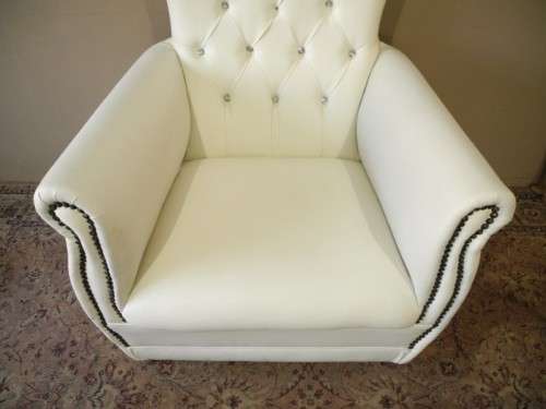An exceptional oversized Queen wing back chair in durable white faux leather. Great "Feature" chair