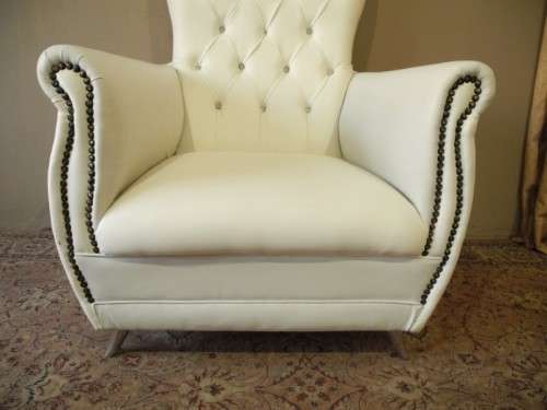 An exceptional oversized Queen wing back chair in durable white faux leather. Great "Feature" chair