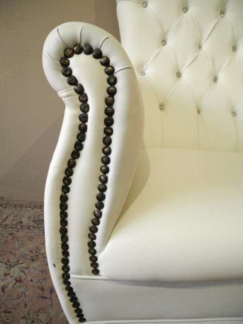 An exceptional oversized Queen wing back chair in durable white faux leather. Great "Feature" chair