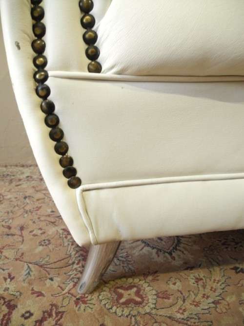 An exceptional oversized Queen wing back chair in durable white faux leather. Great "Feature" chair