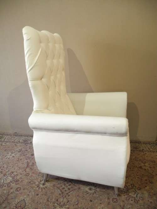 An exceptional oversized Queen wing back chair in durable white faux leather. Great "Feature" chair