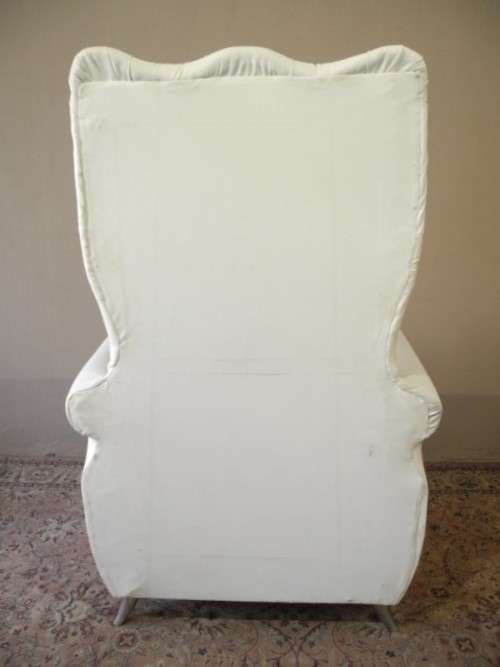 An exceptional oversized Queen wing back chair in durable white faux leather. Great "Feature" chair