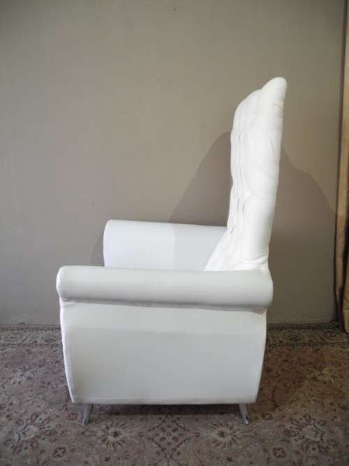 An exceptional oversized Queen wing back chair in durable white faux leather. Great "Feature" chair