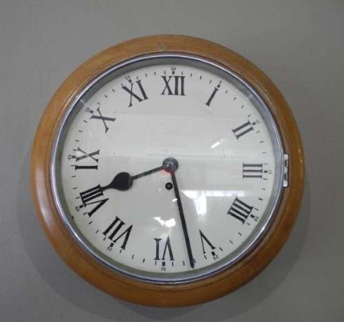 BARGAIN CLOCKS!!A vintage round faced clock in a wood wall casing. Lifespace Sale