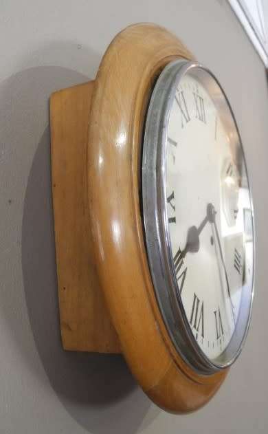 BARGAIN CLOCKS!!A vintage round faced clock in a wood wall casing. Lifespace Sale