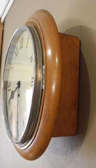 BARGAIN CLOCKS!!A vintage round faced clock in a wood wall casing. Lifespace Sale