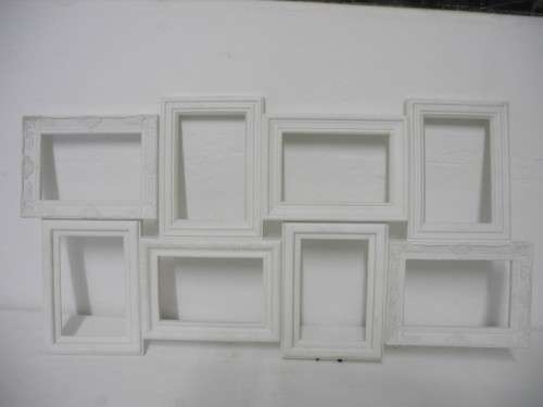 A stunning white plastic wall mounted photo frame for 8 photos. Lifespace Sale